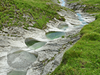 Eine lange Reihe von Gletschermühlen auf der Alp Mora oberhalb von Trin